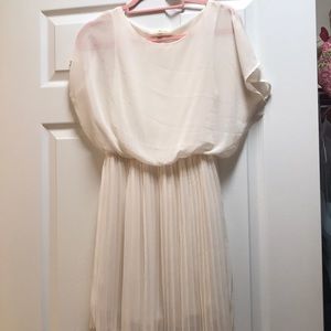 Cream dress with pleated skirt